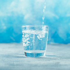 Wall Mural - Pouring water from bottle into glass