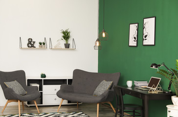 Wall Mural - Modern living room interior with workplace near green wall