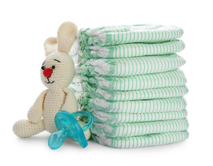 Wall Mural - stack of disposable diapers and baby accessories on white background