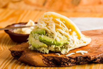 Typical Latin American food, arepa for breakfast with cheese, avocado and chicken