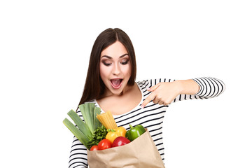 Beautiful woman holding grocery shopping bag on white background