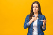 © denis_vermenko - Young woman having flue taking thermometer. Isolated against yellow background. Beautiful young woman is sick with a high temperature, a thermometer, isolated close-up. Cold, flu concept.