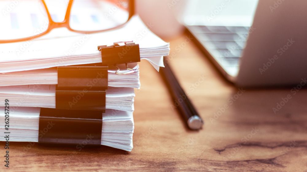 Stack of documents placed on a business desk in a business office.