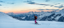 Switzerland, Bagnes, Cabane Marcel Brunet, Mont Rogneux, woman ski touring in the mountains at dusk