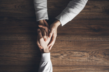 woman and man hand on table