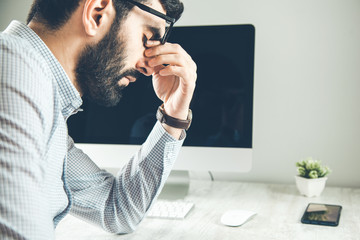 Wall Mural - sad man with computer on the desk