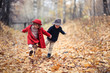 © natalialeb - boy and girl in hats walk in park, autumn mood