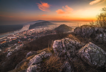 Wall Mural - View of a Small City near Danube River at Sunrise. Hainburg an der Donau, Austria as seen from Hundsheimer Hill with Rocky Foreground.