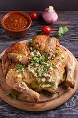 Wall Mural - Roasted chicken with garlic on wooden tray