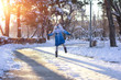 © Lumppini - girl soars in a snowy park at sunset.