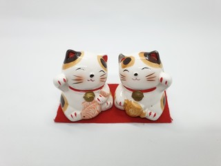 Wall Mural - Porcelain Cat Statue representing luck symbol and sign for traditional chinese culture presented in white isolated background