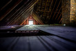 Old attic space with roof rafters and a window