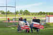 © soupstock - Parents sitting in folding chairs watching a high school baseball game