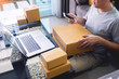 © snowing12 - Startup small business SME, entrepreneur owner  using smartphone or note book taking receive and checking online purchase shopping order to preparing pack product box.
