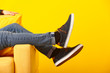 © Pixel-Shot - Stylish man in shoes sitting in armchair on color background