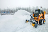 Fototapeta Uliczki - Snow removal works, snow removal machine in action