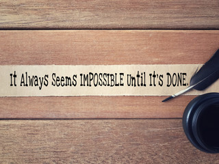 Wall Mural - Motivational and inspirational wording - It Always Seems Impossible Until It’s Done written on a ripped paper.