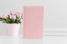 Pink Book Mockup With Books And Pink Roses In A Pot On A White Table.