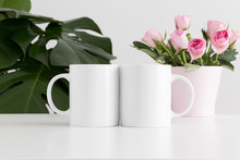 Two Mugs Mockup With Pink Roses In A Pot And A Monstera Plant.