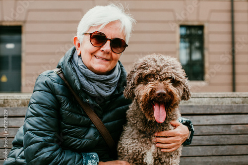 Middle Aged Woman With White Hair Enjoying Her Spanish Spaniel By