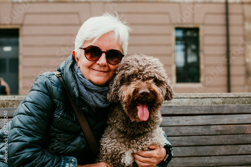 Middle Aged Woman With White Hair Enjoying Her Spanish Spaniel By
