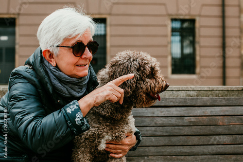 Middle Aged Woman With White Hair Enjoying Her Spanish Spaniel By