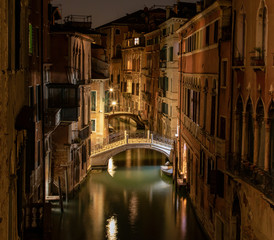 Wall Mural - View into a small canal in Venice by night