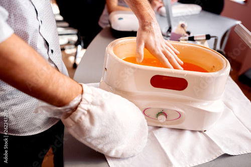Fotografía Manicure treatment with one hand having flannel glove and other being soaked wit