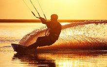 Kitesurfer At Sunset With Water Splashes