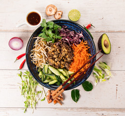 Bun bo nam bo asian food background with various ingredients on wooden table.