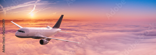 Canvastavla  Commercial airplane jetliner flying above dramatic clouds.