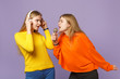 © ViDi Studio - Two puzzled blonde twins sisters girls in colorful clothes liste