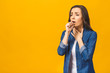 © denis_vermenko - Closeup portrait of cute sick young woman having sore throat isolated, holding hand on her neck/Throat pain, painful swallowing concept/ Inflammation of the upper respiratory tract.
