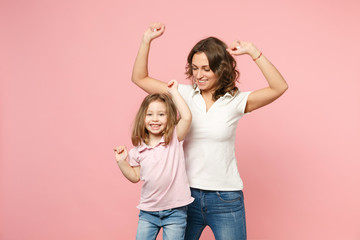 Wall Mural - Woman in light clothes have fun with cute child baby girl. Mother, little kid daughter isolated on pastel pink wall background, studio portrait. Mother's Day, love family, parenthood childhood concept