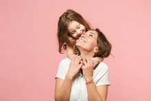 Woman In Light Clothes Have Fun With Cute Child Baby Girl. Mother, Little Kid Daughter Isolated On Pastel Pink Wall Background, Studio Portrait. Mother's Day, Love Family, Parenthood Childhood Concept