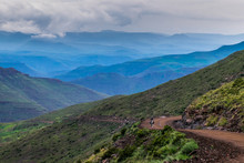 Eternal Mountain View With Road And Basotho Man Riding A Basotho Pony, Lesotho, Africa