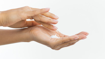 Wall Mural - Skin care. Woman applying moisturizing cream to her hands