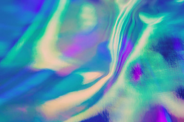 Abstract trendy holographic background in 80s style. Real texture in violet, pink and mint colors with scratches and irregularities. Synthwave. Vaporwave style. Retrowave, retro futurism, webpunk