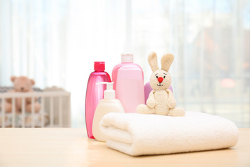 Wall Mural - baby cosmetic products, toy and towel on table indoors. space for text