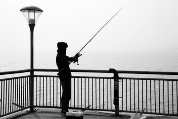 man fishing at sunset