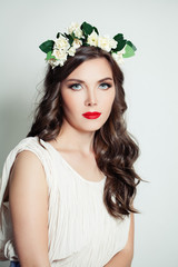 Attractive model in flower crown. Woman spring makeup portrait