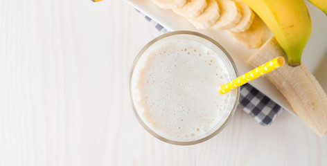 Fresh Made Chocolate Banana Smoothie on a wooden table. Selective focus. Milkshake with almonds. Protein diet. Healthy food and drink concept.