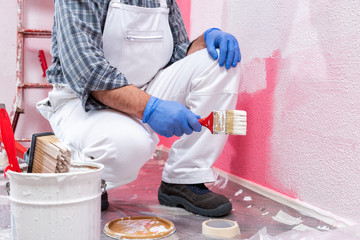 House painter worker at work in the construction site. Building.