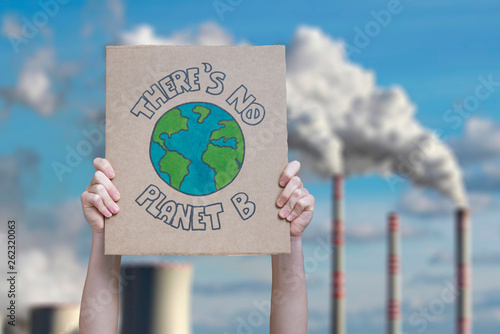 Fotografía Climate change manifestation poster on an industrial fossil fuel burning