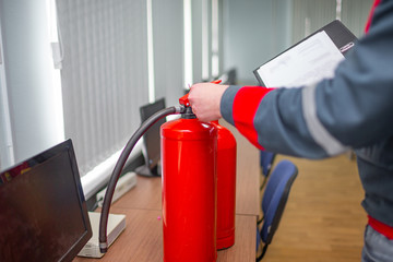 Wall Mural - engineer professional are checking a fire extinguisher using clipboard or checking industrial fire c