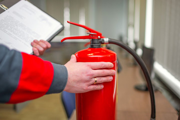 Wall Mural - engineer professional are checking a fire extinguisher using clipboard or checking industrial fire c