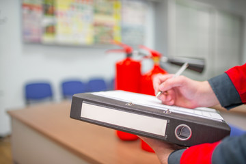 Wall Mural - engineer professional are checking a fire extinguisher using clipboard or checking industrial fire c