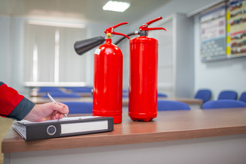 Wall Mural - engineer professional are checking a fire extinguisher using clipboard or checking industrial fire c