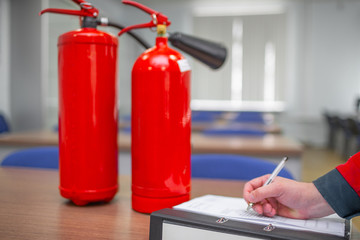 Wall Mural - engineer professional are checking a fire extinguisher using clipboard or checking industrial fire c