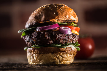 Canvas Print - Tasty beef burger with spinach leaves salad onion tomato and cheese